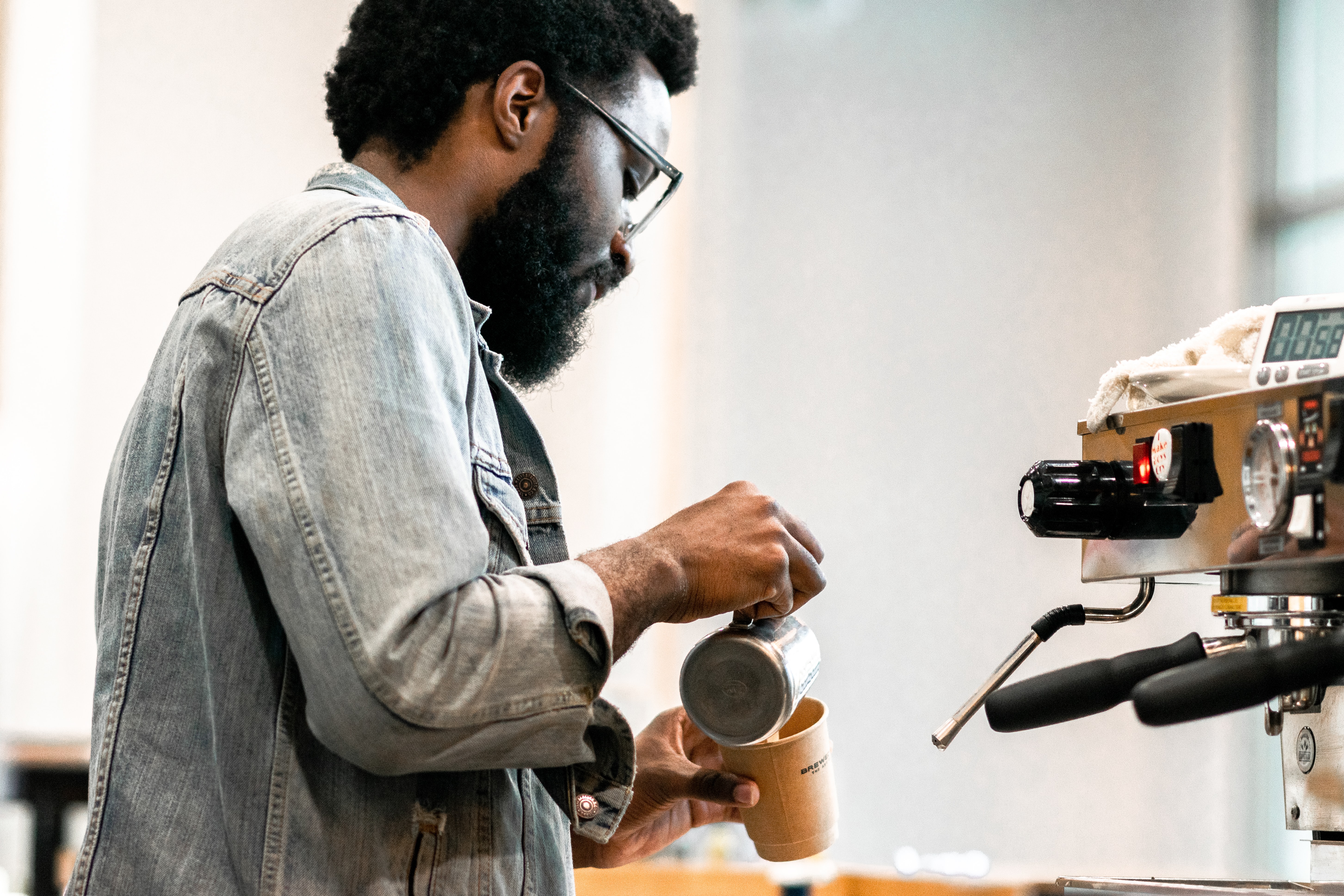 a guy pouring a latte